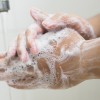 A person thoroughly washing their hands.