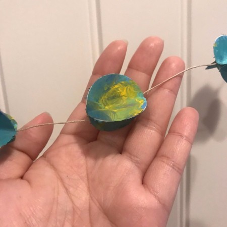 Splatter Paint Sticker Circle Garland  - closeup of one sticker assembly on the twine