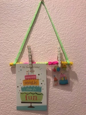 Hanging Memo Holder - hanging on the wall with two items clipped on