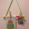Hanging Memo Holder - hanging on the wall with two items clipped on
