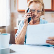 An older woman calling for help on a bill.