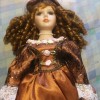 Value of an Ashley Belle Doll - doll with ringlets, bronze dress with white lace trim