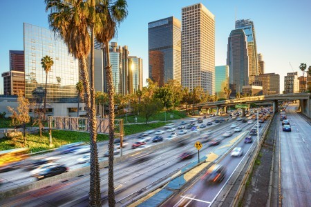 A Los Angeles freeway with buildings in the distance.