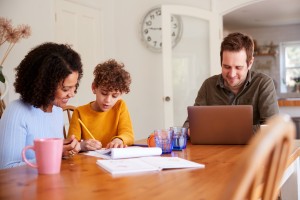 A family working around a kitchen table.