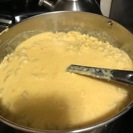 adding cheese to hot milk