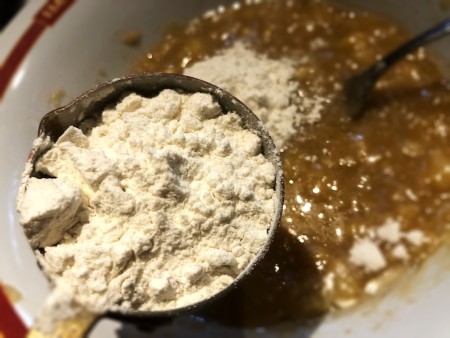 adding flour to batter