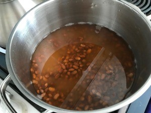 A pot of beans soaking in water.