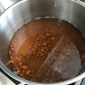 A pot of beans soaking in water.