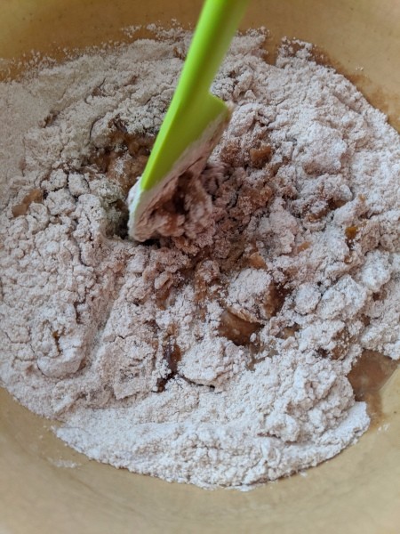 adding flour to batter