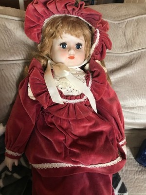 Identifying a Porcelain Doll - doll wearing a red velvet dress and matching hat