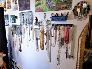 Hanging Necklaces Using Re-purposed Item - wall covered in hanging necklaces and other crafts