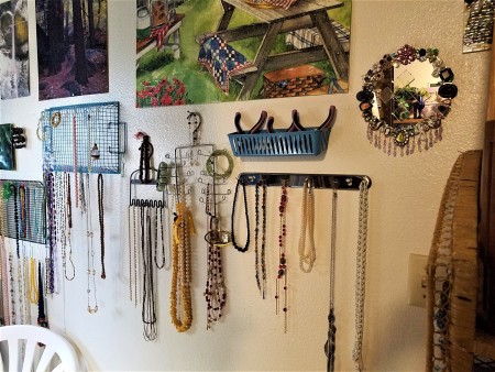 Hanging Necklaces Using Re-purposed Items - necklaces hung and pliers in blue basket