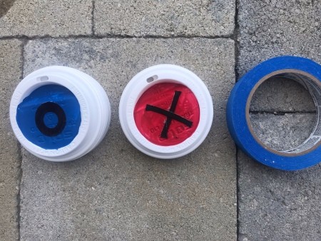 Outdoor Tic Tac Toe Game - lids and a roll of blue tape