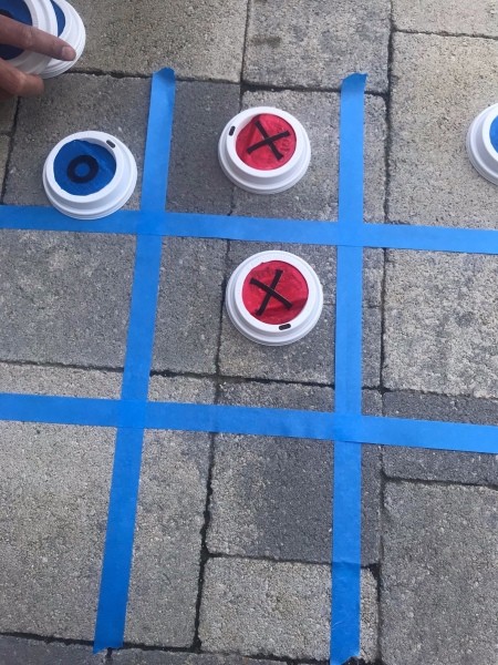 Outdoor Tic Tac Toe Game - tic tac game board made with painter's tape on patio