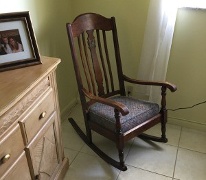 Value of a Murphy Rocking Chair - dark wood old rocking chair in corner of room