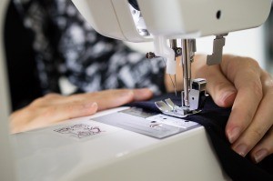 A seam being sewed on a machine.