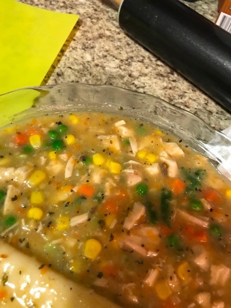 pie filling with pie dough in baking dish