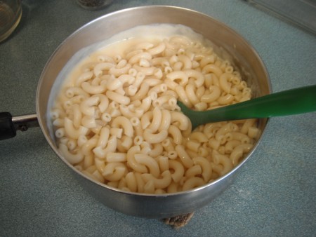 Macaroni added to cheese sauce