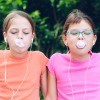 Two girls chewing gum.