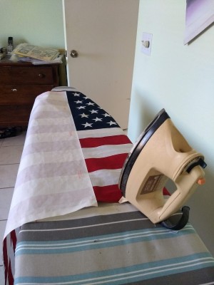 Adhering Heat and Bond to stiffen an American flag.