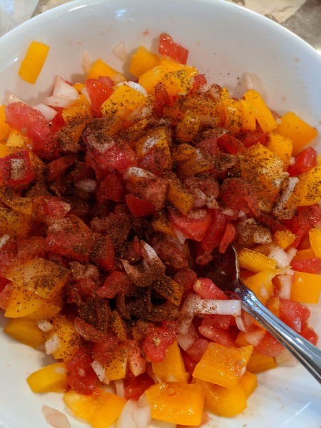 adding spices to chopped veggies