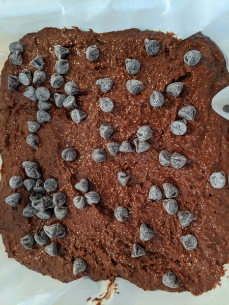 Chocolate chips on batter in pan