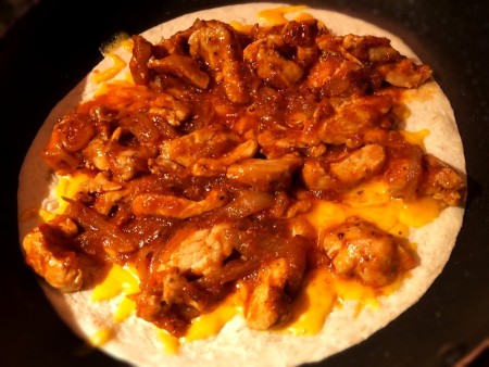 add Chicken & onions to cheese on tortilla