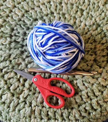 Crochet "Go Back" Bowl - ball of three colors of yarn wound together, hook, scissors