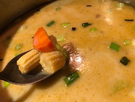 veggies in spoon over soup