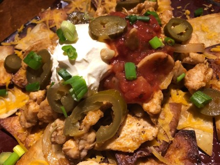 peppers, green onions,sour cream & salsa added to nachos