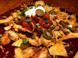 Loaded Chicken Nachos on plate