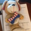 Identifying a Stuffed Toy - tan and white stuffed dog with a red, white, and blue bone on its chest