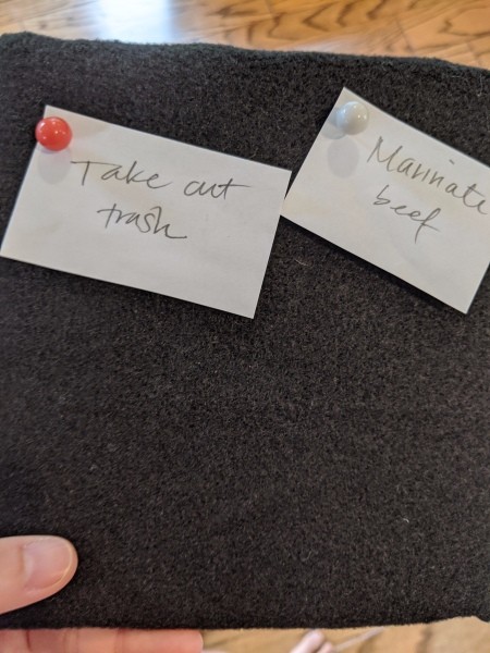 Inexpensive Felt Message Board - notes on scraps of paper attached to board with push pins