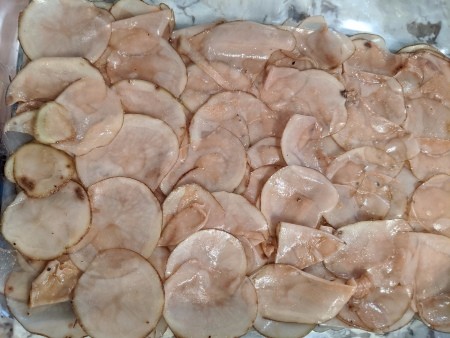 sliced Potatoes in baking dish