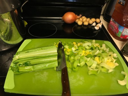 A head of celery being chopped.