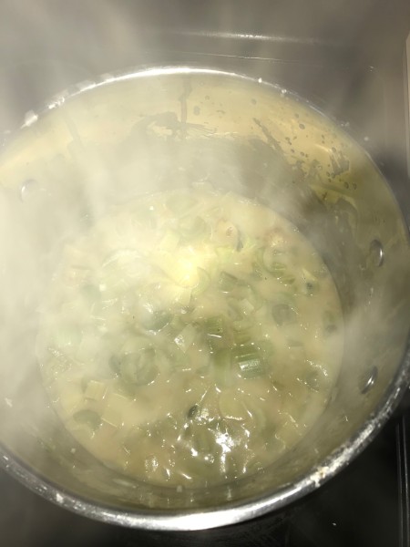 Steam rising from a soup pot.