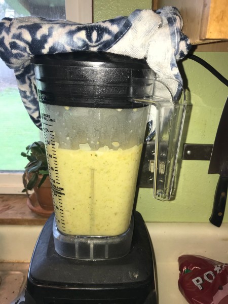 The cooked soup being blended.