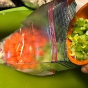 Adding celery to the freezer bag.