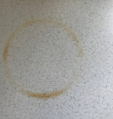 Removing a Burn Mark on a Formica Countertop - brown circular burn mark on a light countertop