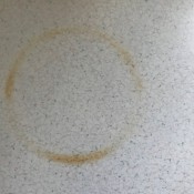 Removing a Burn Mark on a Formica Countertop - brown circular burn mark on a light countertop