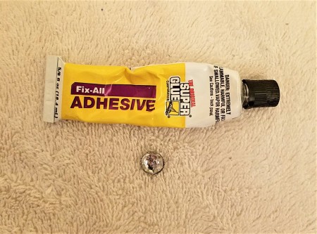 A bottle of Fix-All Adhesive.