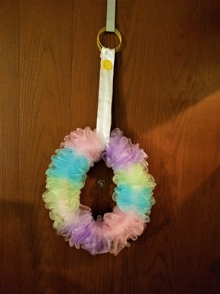 Pretty Recycled Pipe Insulation Spring Pouf Wreath - finished wreath with ribbon hanger wrapped over bangle style bracelets then hung from an ofer the door hook