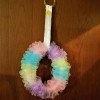 Pretty Recycled Pipe Insulation Spring Pouf Wreath - finished wreath with ribbon hanger wrapped over bangle style bracelets then hung from an ofer the door hook