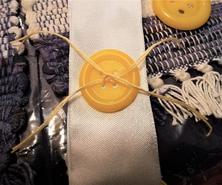 Pretty Recycled Pipe Insulation Spring Pouf Wreath - adding a button