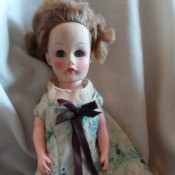 Identifying a Doll - doll with messed up hair wearing a blue and white floral dress, composition unknown