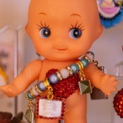 A vintage Kewpie doll wearing a bracelet.