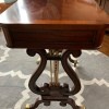 Value of a Vintage Lyre Game Table - game table with two lyre end legs/supports and brass covered wheeled feet