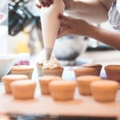 Decorating cupcakes with a frosting bag.