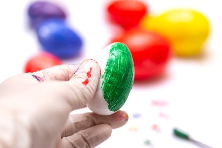 Person painting an egg made of polystyrene