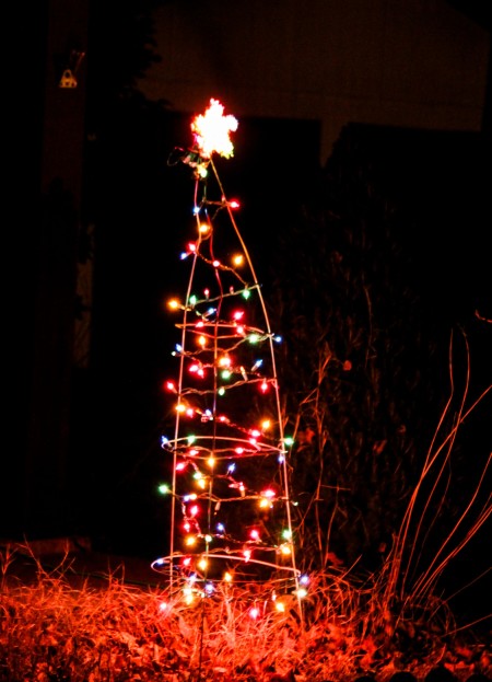 Tomato cage made into a light decorated Christmas Tree